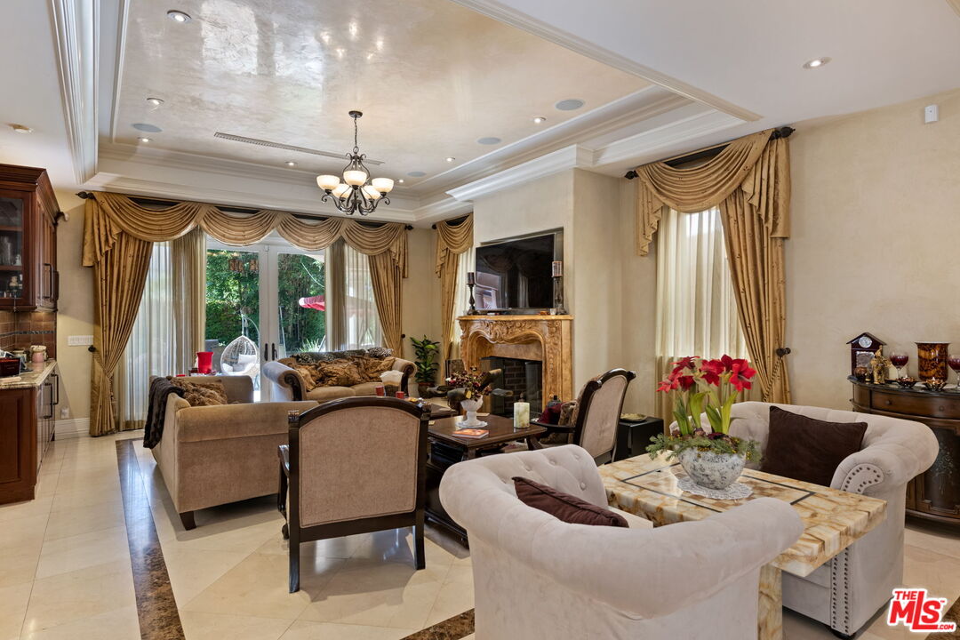 2023 Parnell Avenue Los Angeles, CA 90025 - Photo 8 of 59 a living room with furniture a chandelier and a large mirror