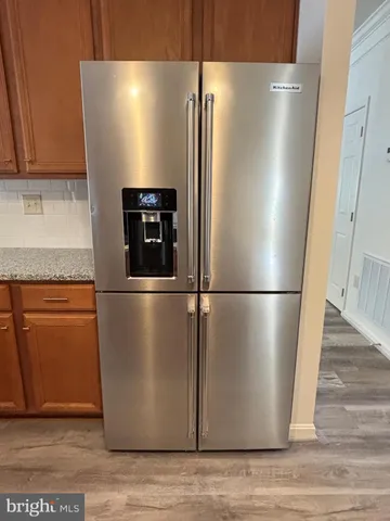 a view of a refrigerator in kitchen and stainless steel appliances