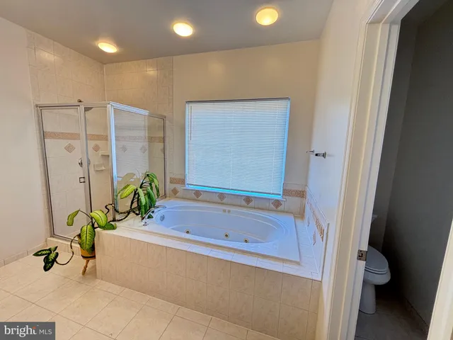 a bathroom with a tub and shower