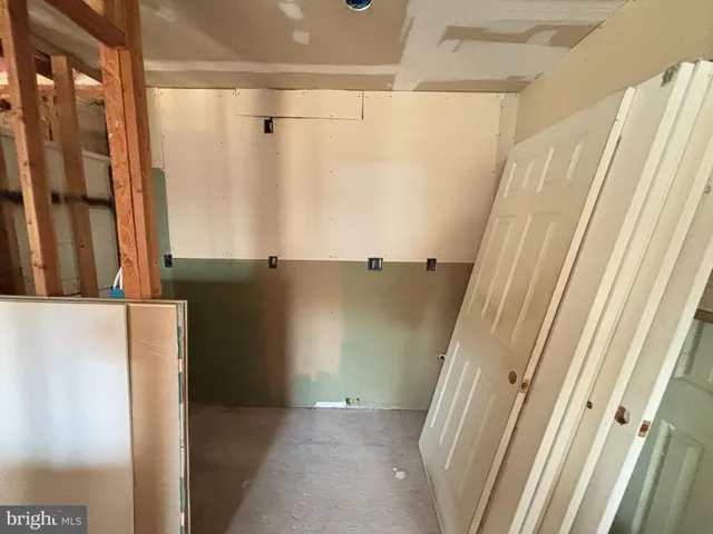 a view of a hallway with furniture and a window