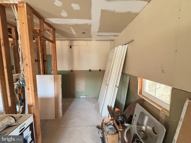 a living room with furniture a rug and white walls