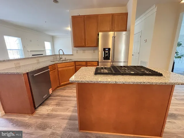 a kitchen with granite countertop sink stove and refrigerator