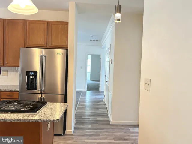 a kitchen with a refrigerator and a sink