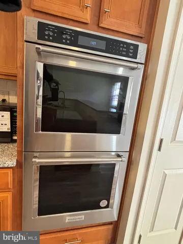 a stove top oven sitting inside of a kitchen