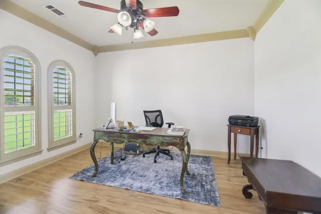a workspace with furniture window and wooden floor