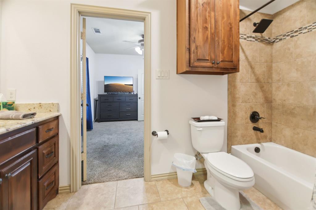 15110 Rutledge Lane Talty, TX 75126 - Photo 19 of 40 a bathroom with a sink a toilet and shower