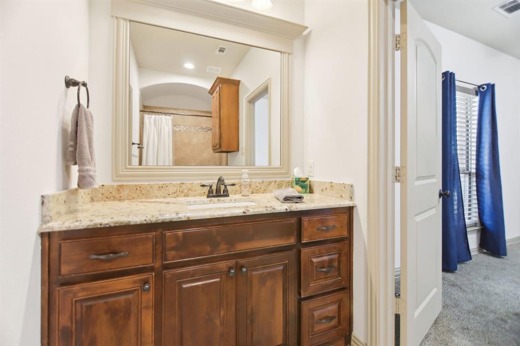 15110 Rutledge Lane Talty, TX 75126 - Photo 20 of 40 a bathroom with a granite countertop sink and a mirror