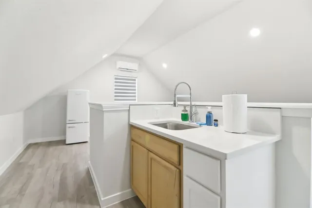 a kitchen with a sink a stove and cabinets