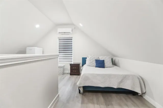 a bedroom with a bed and window