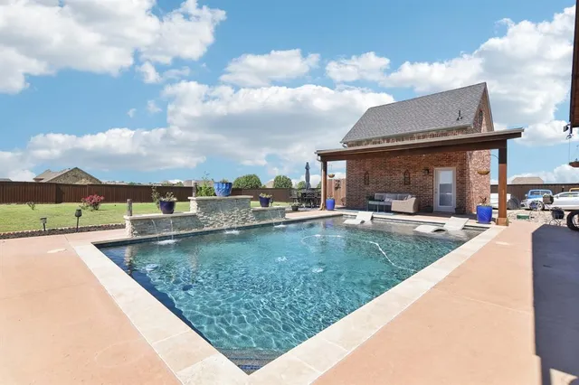 a view of a swimming pool and a chair