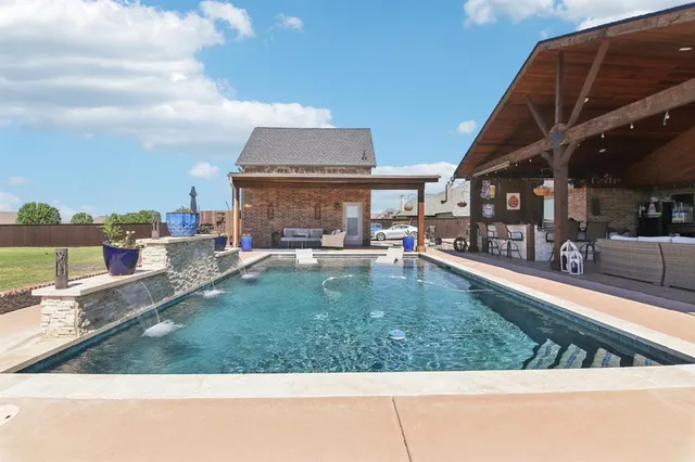 a view of a swimming pool with an outdoor seating