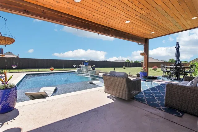 a view of a patio with couches and umbrella