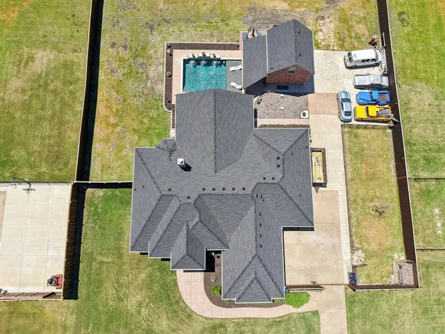 aerial view of a house with a yard