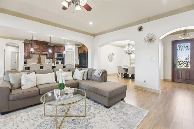 a living room with furniture and a wooden floor