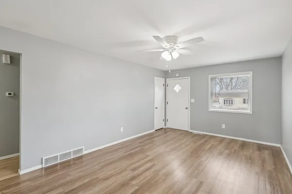 wooden floor in an empty room with a window
