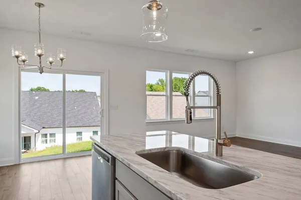a kitchen with a sink and a large window