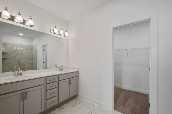 a bathroom with a double vanity sink and a mirror