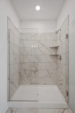 a bathroom with a bathtub and shower