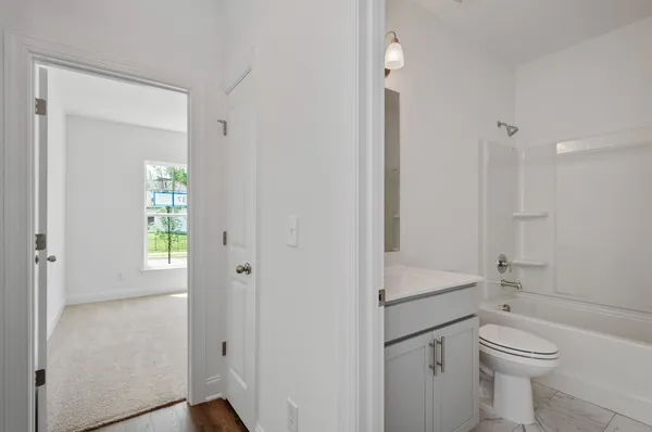 a bathroom with a toilet a sink and shower