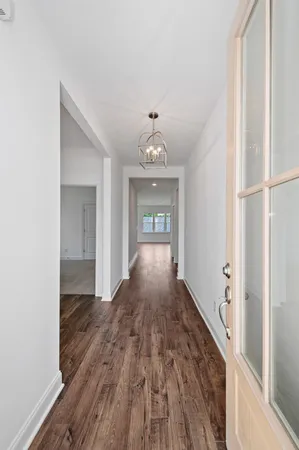 a view of a hallway view with wooden floor and staircase