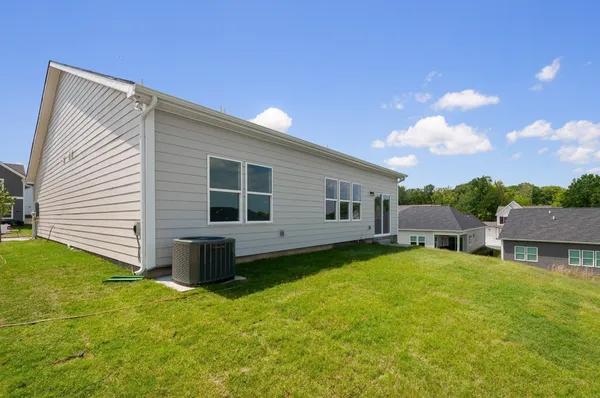 a view of a house with a backyard
