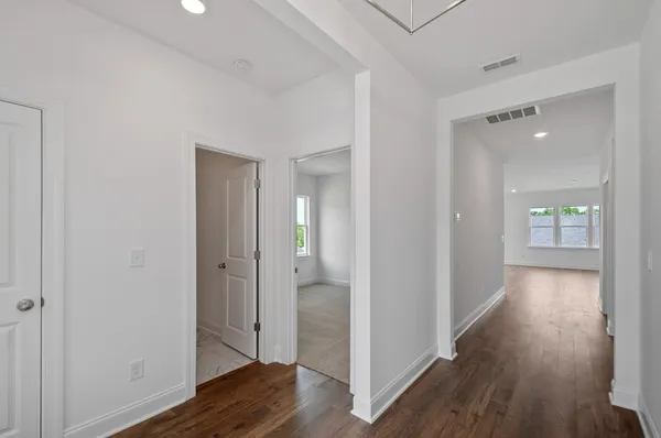 a view of a hallway with wooden floor