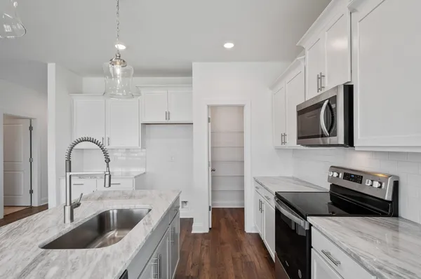 a kitchen with a sink stainless steel appliances and cabinets