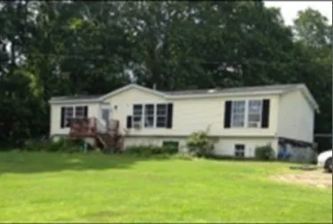 a view of a yard with a house in the background