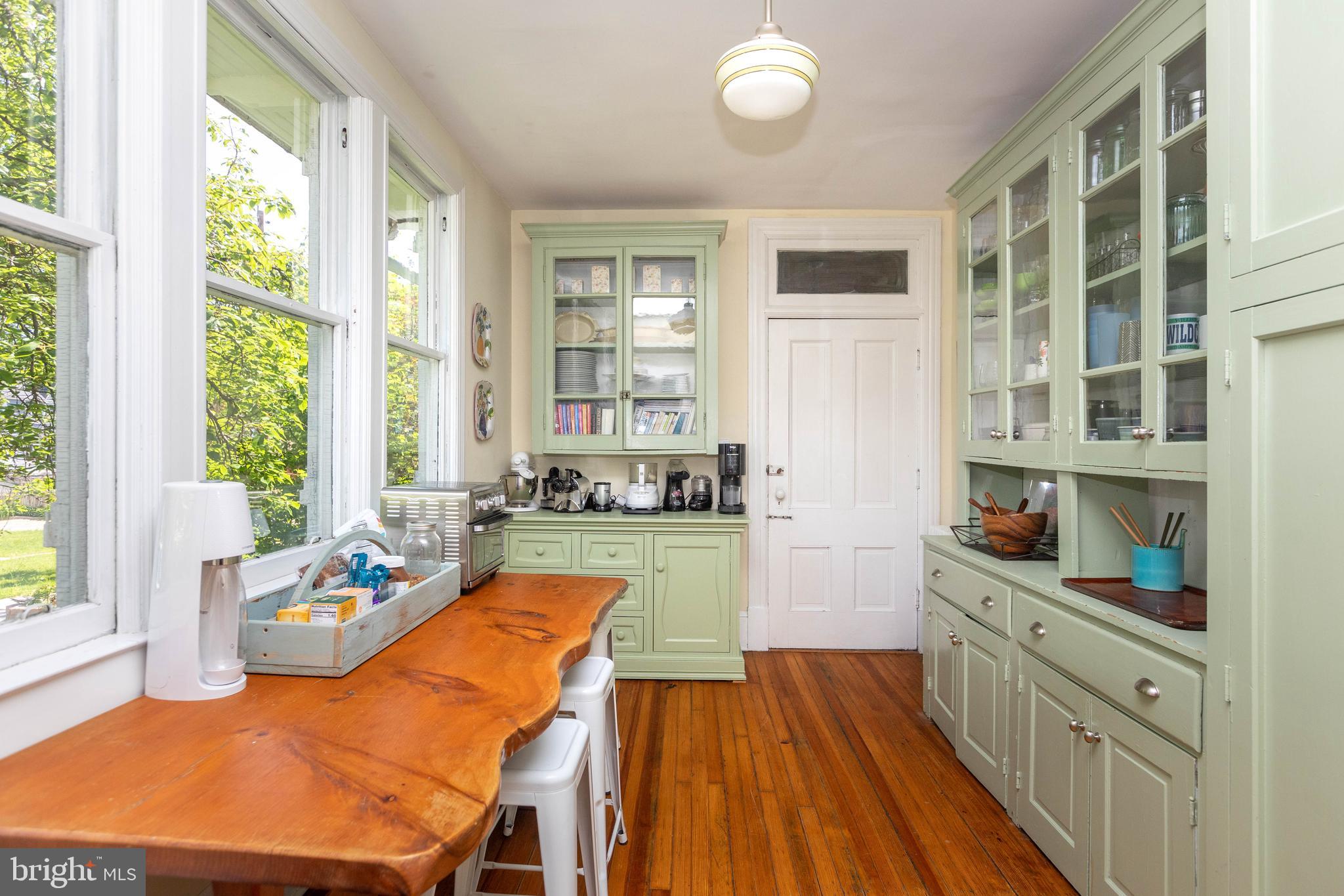 4711 Roland Avenue Baltimore, MD 21210 - Photo 29 of 68 a kitchen with stainless steel appliances granite countertop a stove and a wooden floors