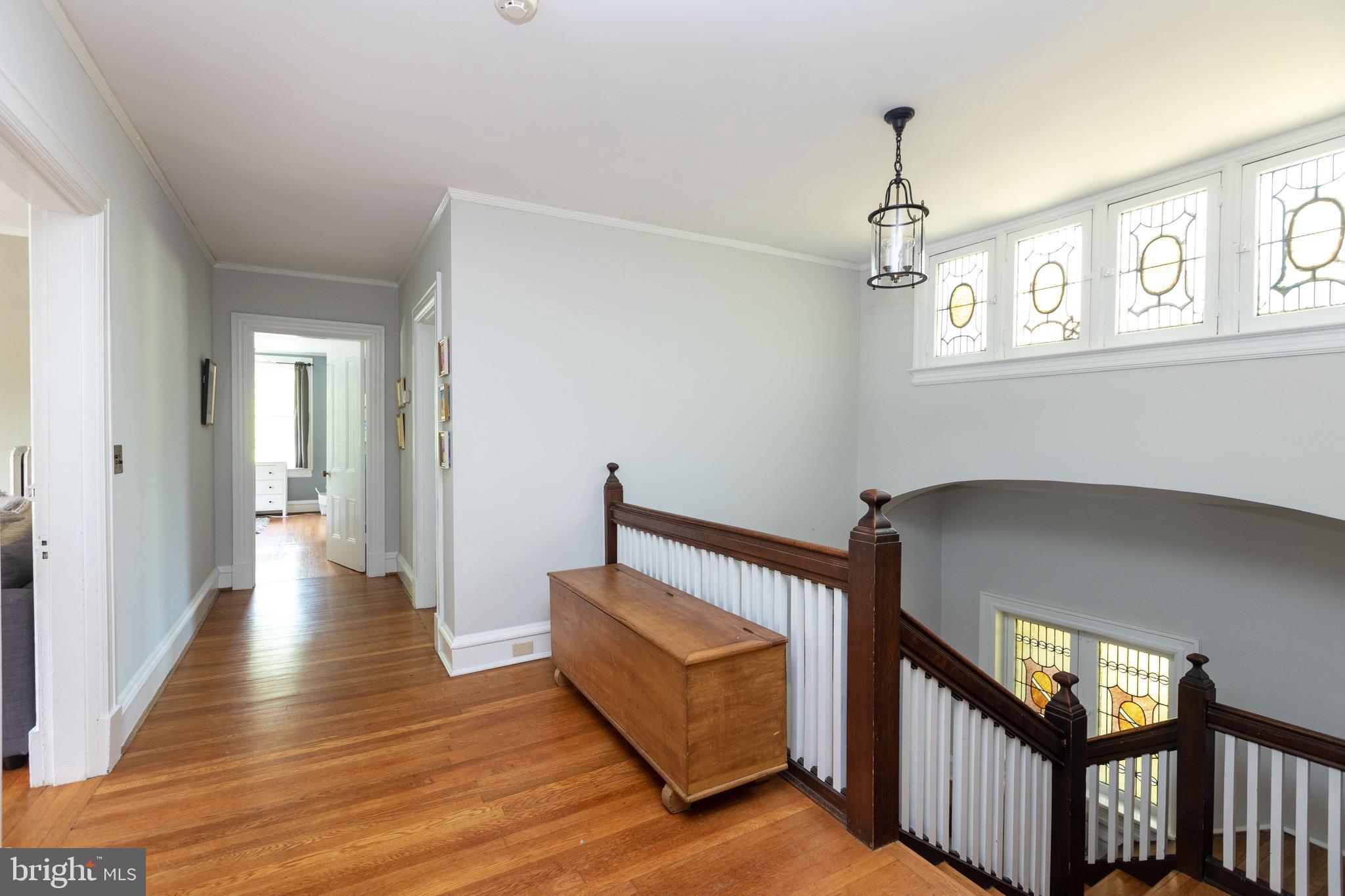 4711 Roland Avenue Baltimore, MD 21210 - Photo 36 of 68 a bedroom with furniture and wooden floor