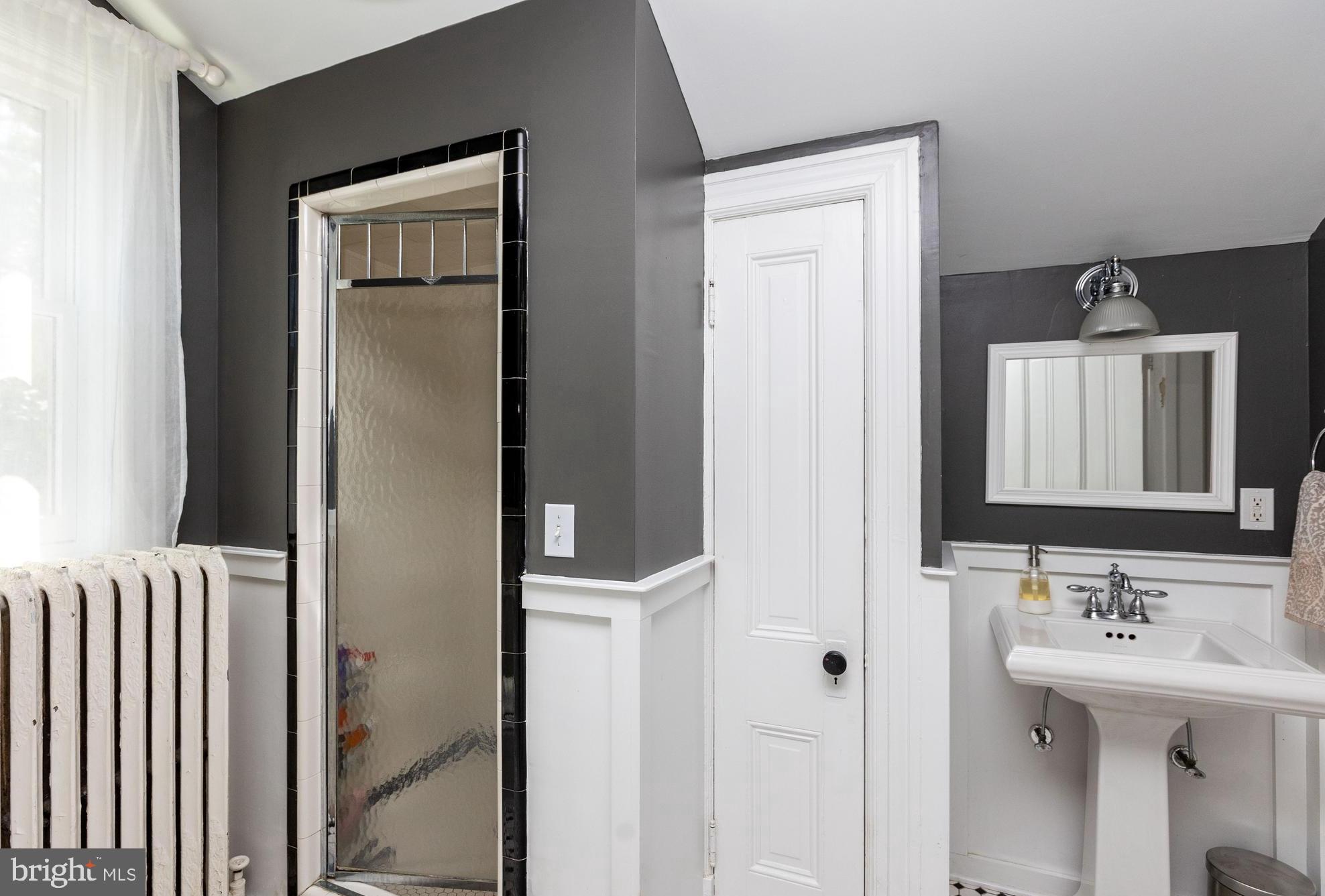4711 Roland Avenue Baltimore, MD 21210 - Photo 39 of 68 a bathroom with a sink and a mirror
