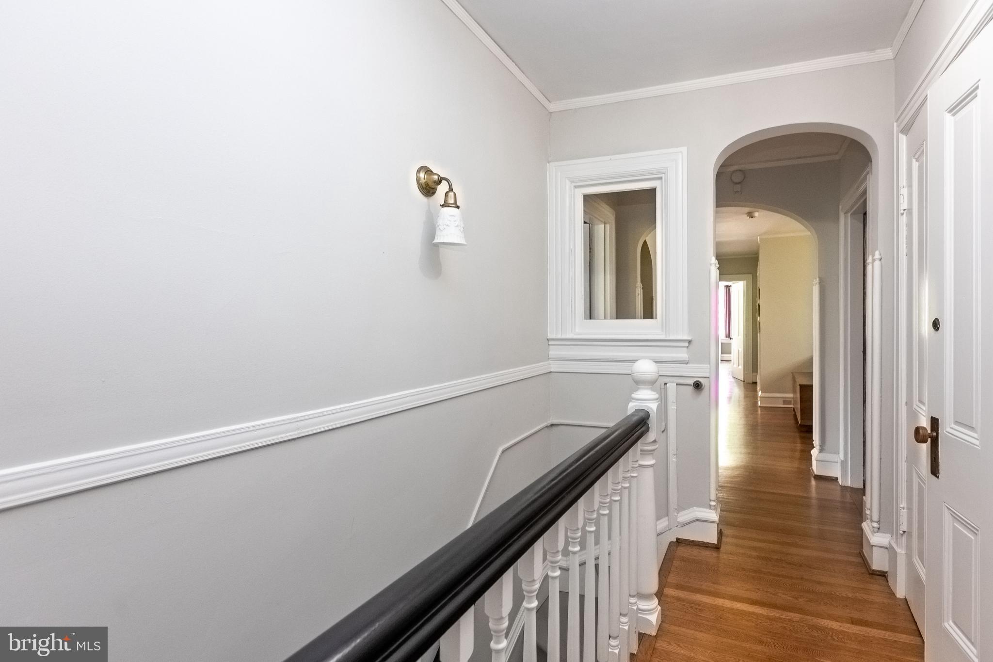 4711 Roland Avenue Baltimore, MD 21210 - Photo 41 of 68 a view of a hallway with wooden floor and staircase