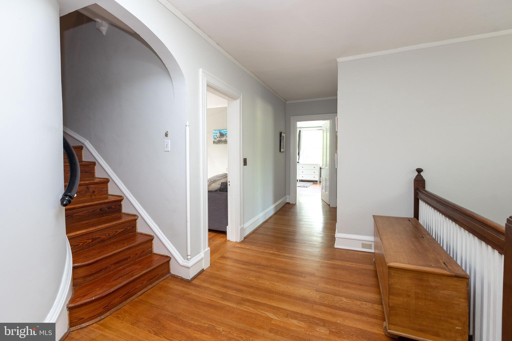 4711 Roland Avenue Baltimore, MD 21210 - Photo 53 of 68 a view of a hallway with wooden floor and staircase