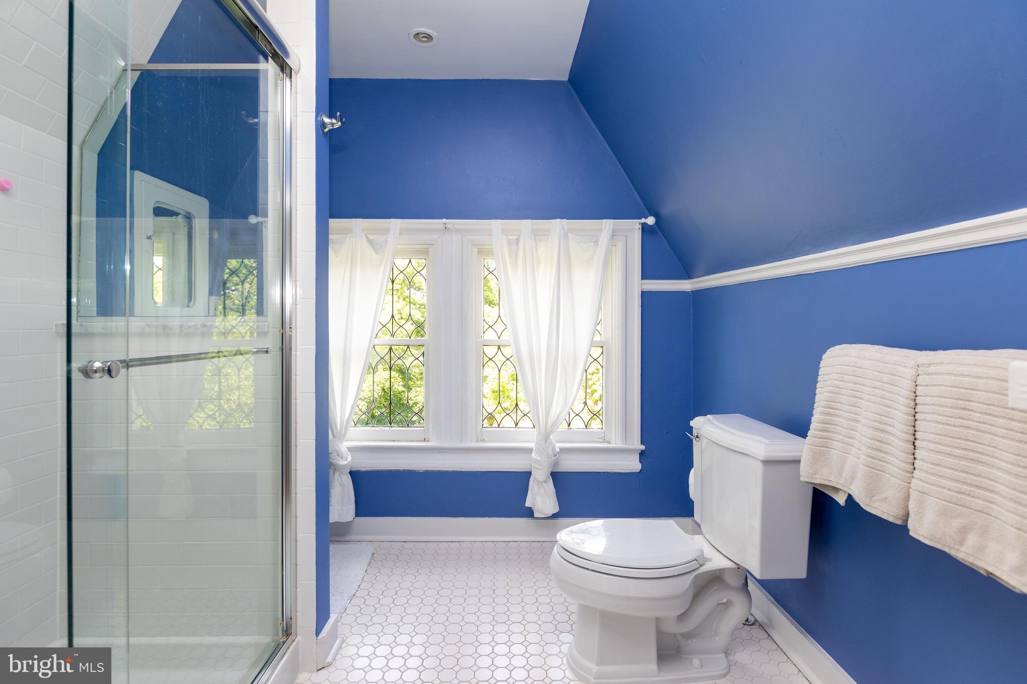 4711 Roland Avenue Baltimore, MD 21210 - Photo 59 of 68 a bathroom with a toilet a sink and a window