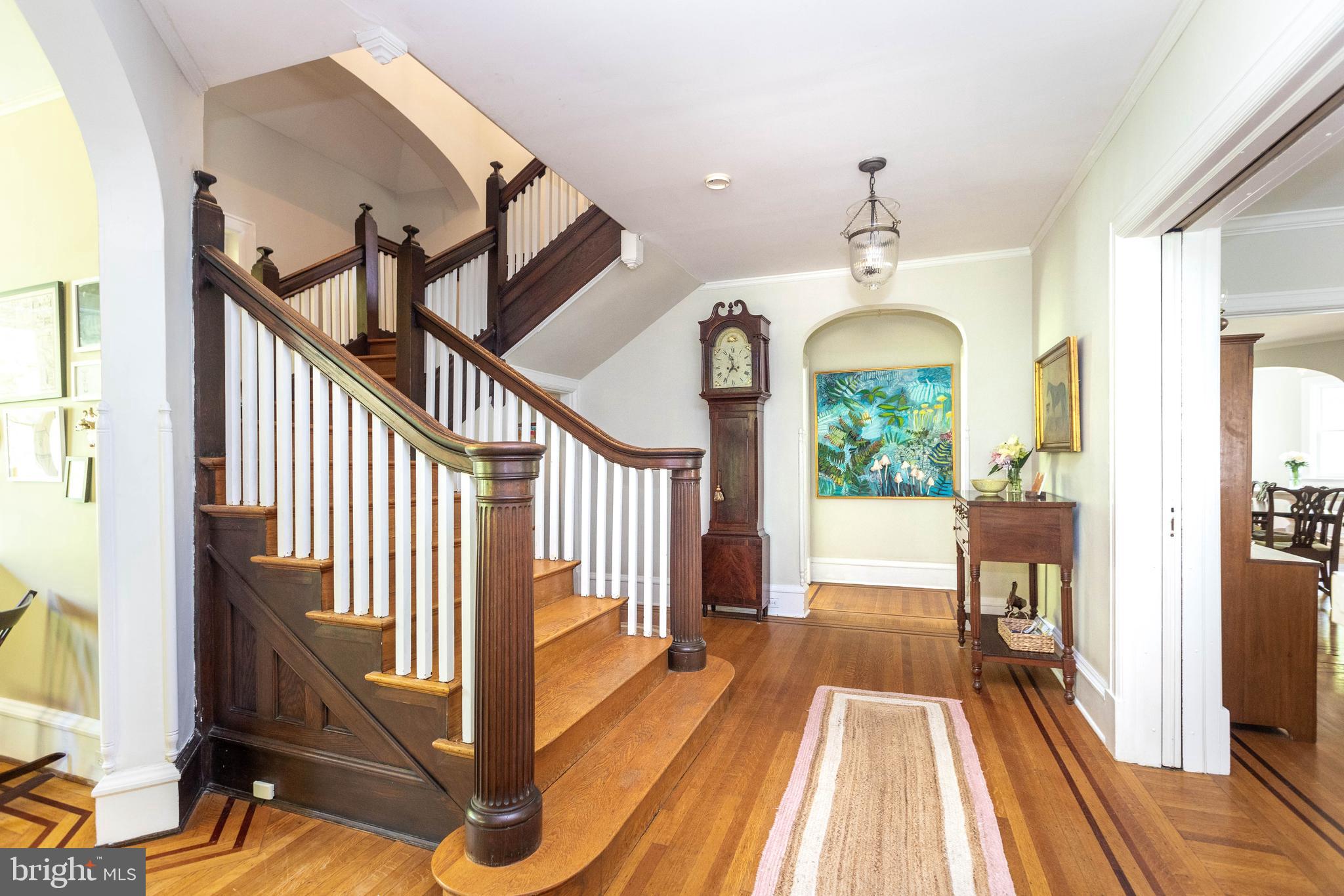 4711 Roland Avenue Baltimore, MD 21210 - Photo 10 of 68 a view of a hallway with wooden floor and staircase