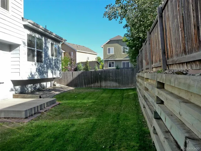 a view of a house with backyard and sitting area