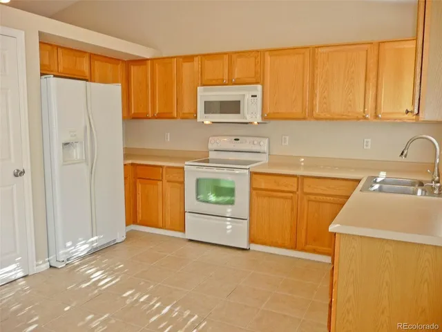 a kitchen with a sink a stove and cabinets