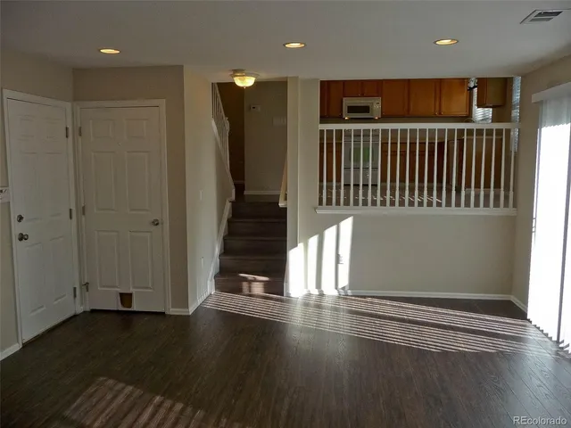 a view of a hallway with wooden floor
