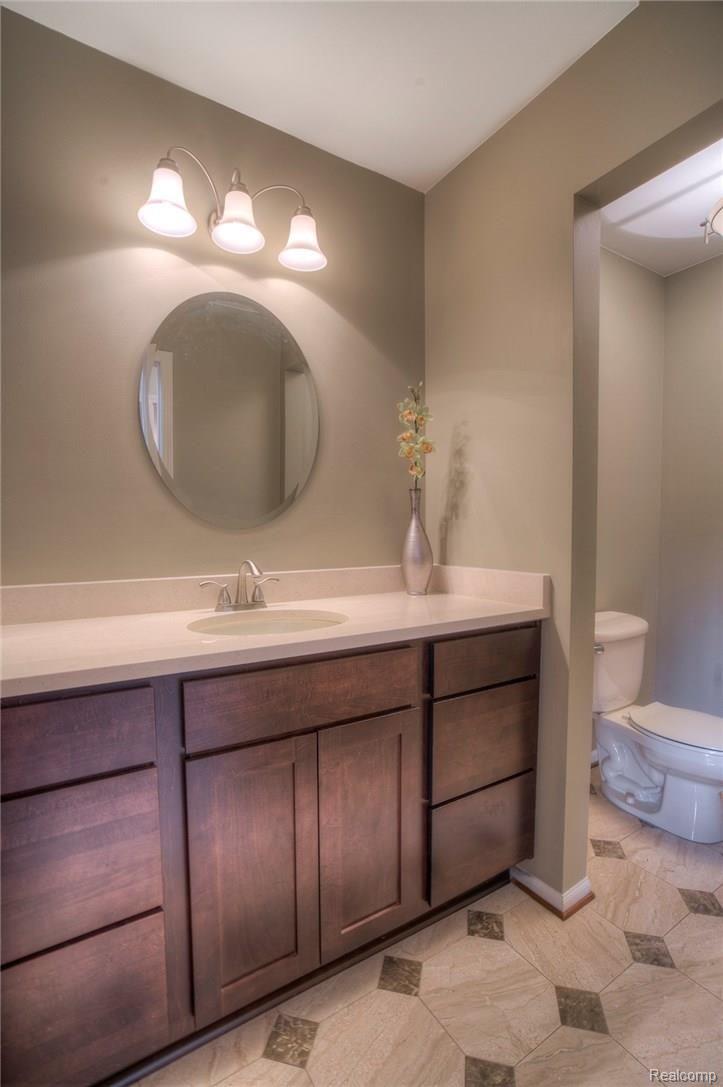 3140 Quail Ridge Circle Rochester, MI 48309 - Photo 26 of 45 Enjoy the updated main floor Half Bath, complete with a new Quartz counter top.