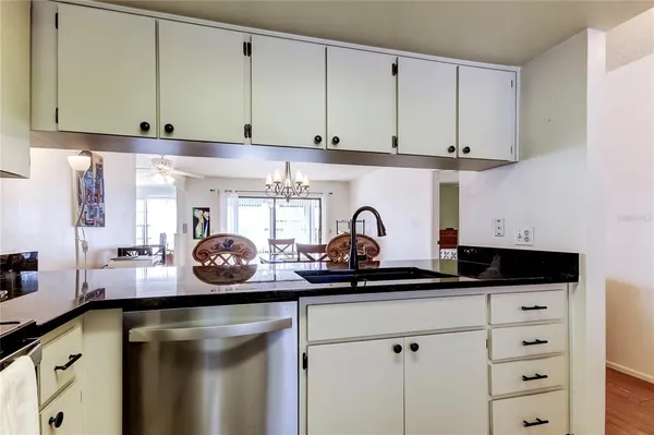 a kitchen with white cabinets and a sink