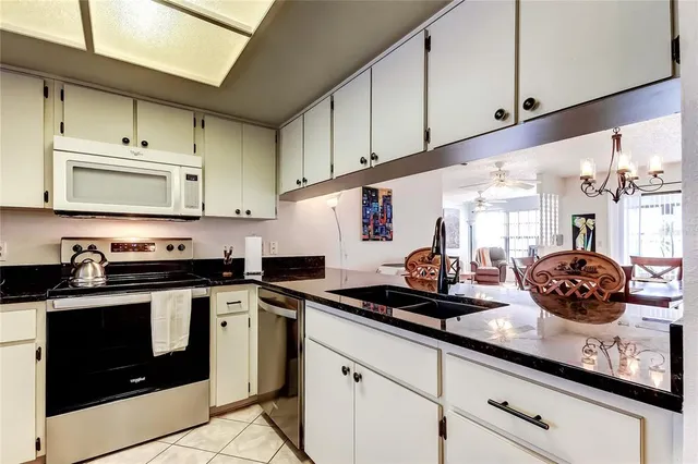a kitchen with stainless steel appliances a stove a sink and cabinets