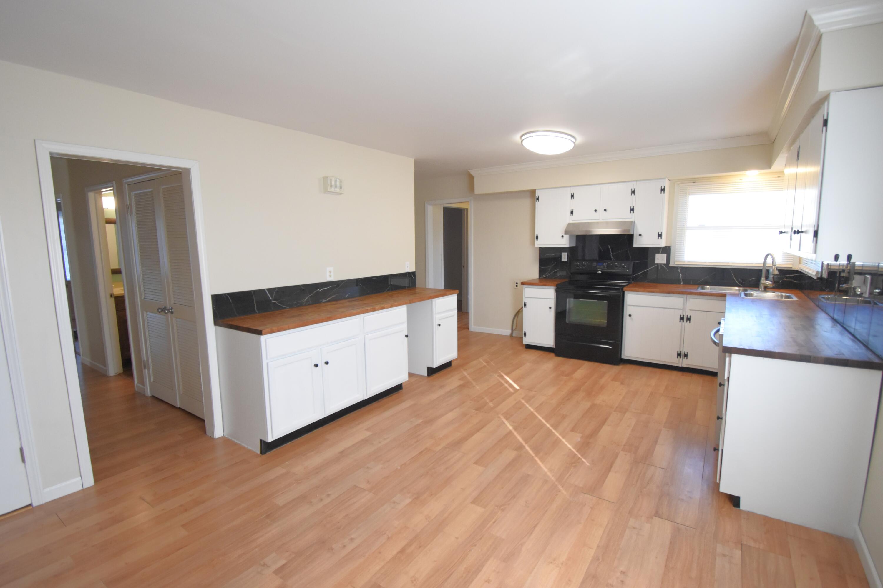 360 East Arnotts Drive Rensselaer, IN 47978 - Photo 15 of 39 a large kitchen with a stove a sink dishwasher a refrigerator and wooden floor