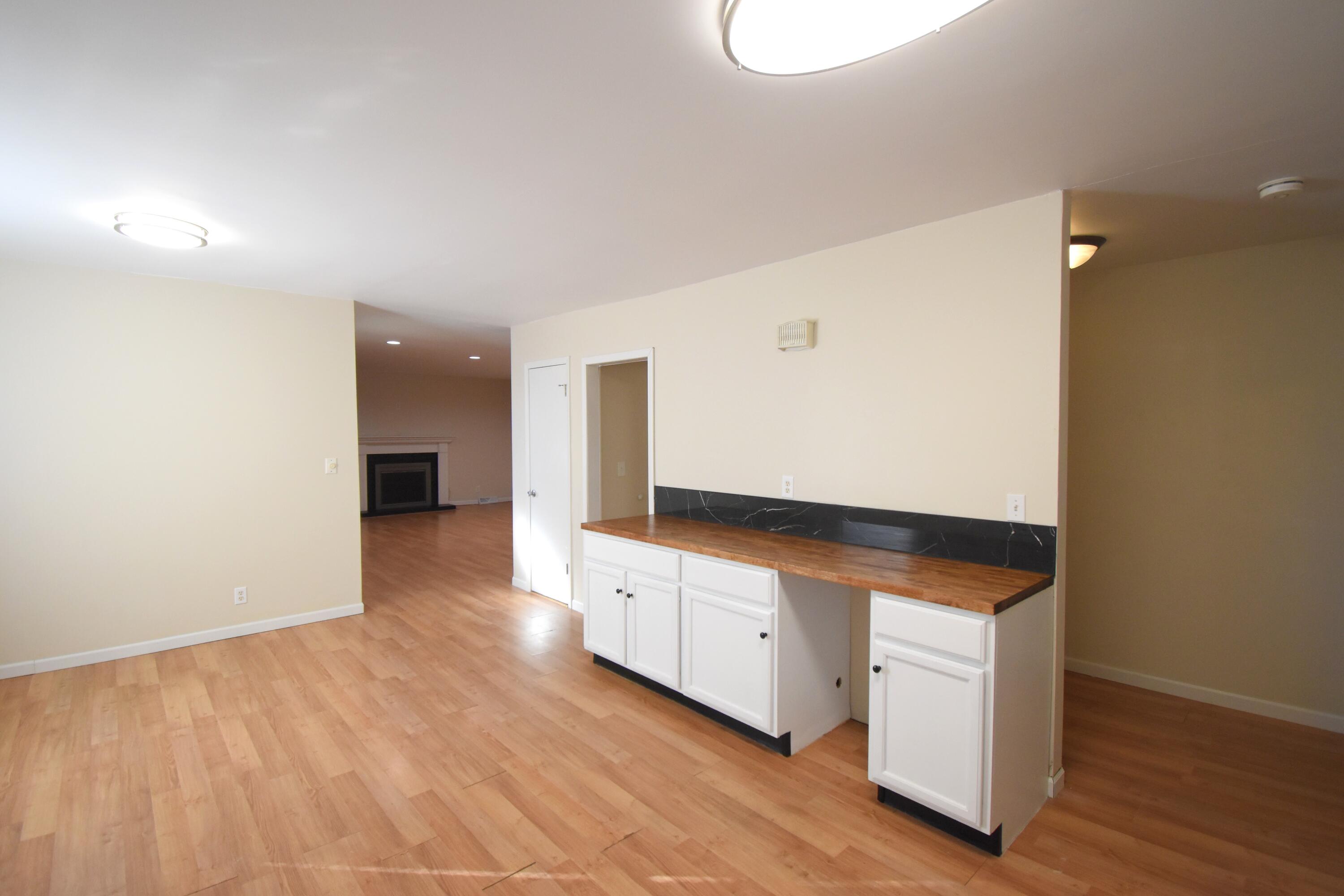 360 East Arnotts Drive Rensselaer, IN 47978 - Photo 18 of 39 a kitchen with granite countertop white cabinets and wooden floor