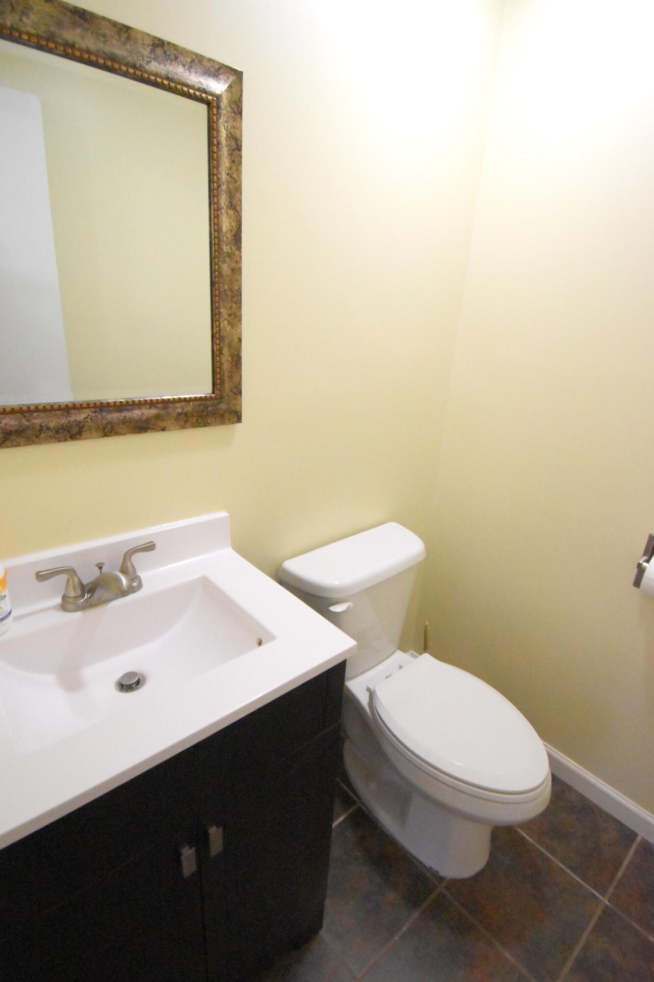 360 East Arnotts Drive Rensselaer, IN 47978 - Photo 33 of 39 a bathroom with a sink a toilet and mirror