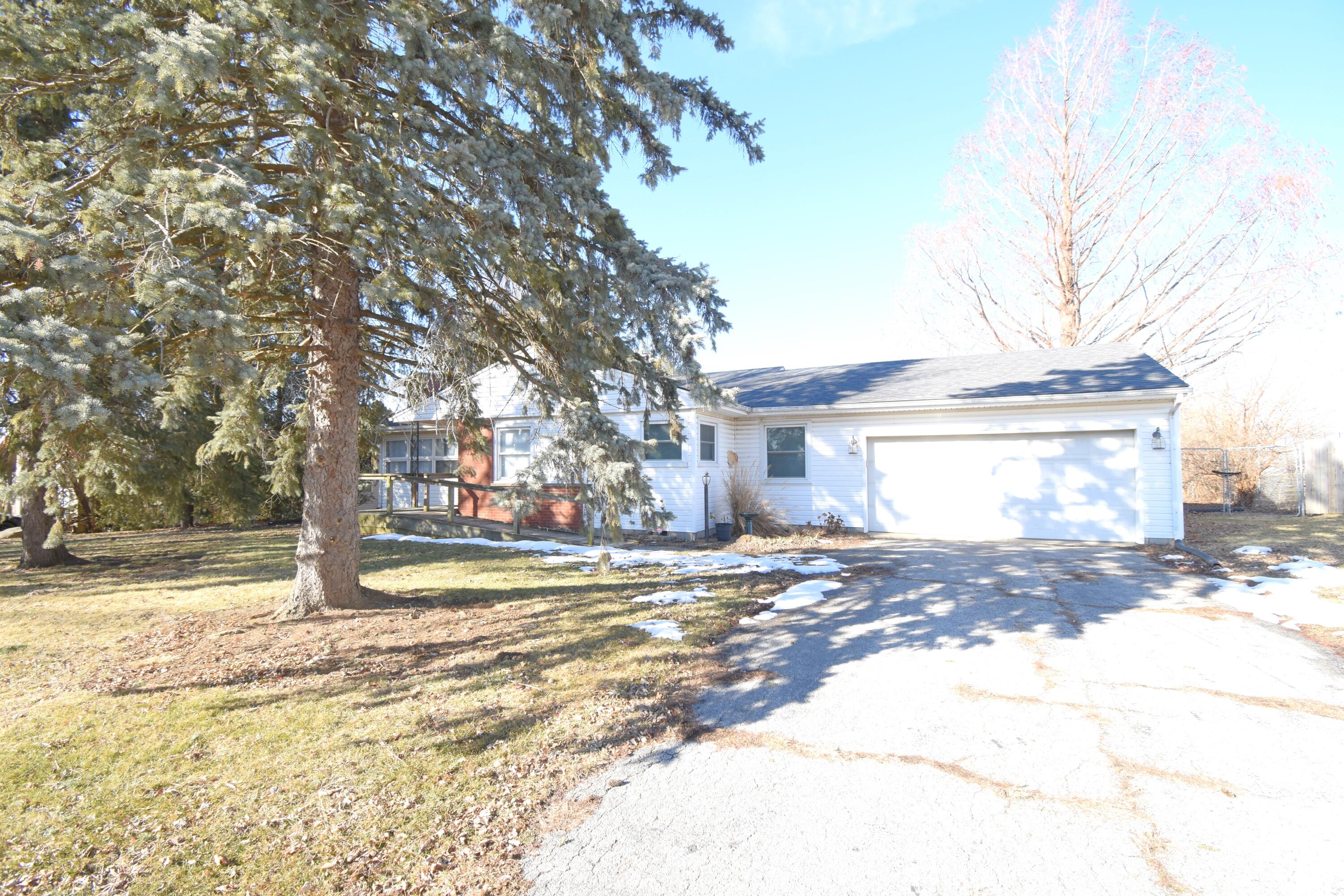 360 East Arnotts Drive Rensselaer, IN 47978 - Photo 5 of 39 a view of a house with a yard and garage