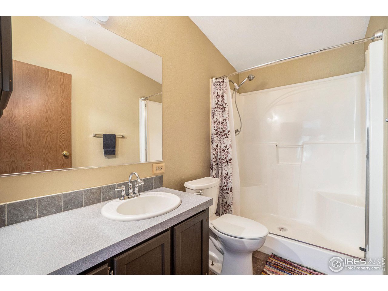 50 Pine Drive Lyons, CO 80540 - Photo 11 of 39 a bathroom with a sink a toilet a mirror and shower