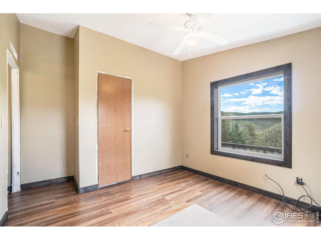 50 Pine Drive Lyons, CO 80540 - Photo 13 of 39 a view of an empty room with wooden floor and a window
