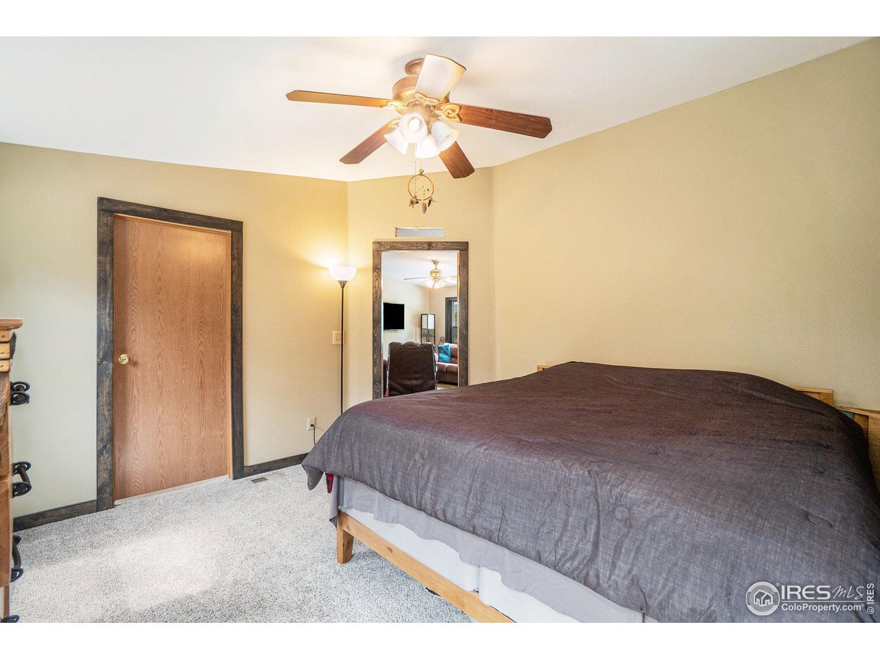 50 Pine Drive Lyons, CO 80540 - Photo 14 of 39 a bedroom with a bed and a chandelier