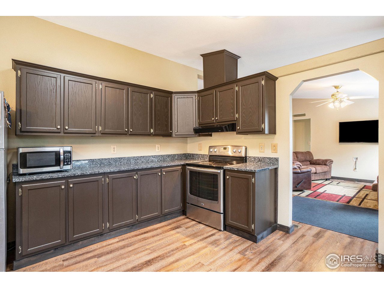 50 Pine Drive Lyons, CO 80540 - Photo 8 of 39 a kitchen with stainless steel appliances granite countertop a stove top oven a sink dishwasher and a microwave oven with cabinets