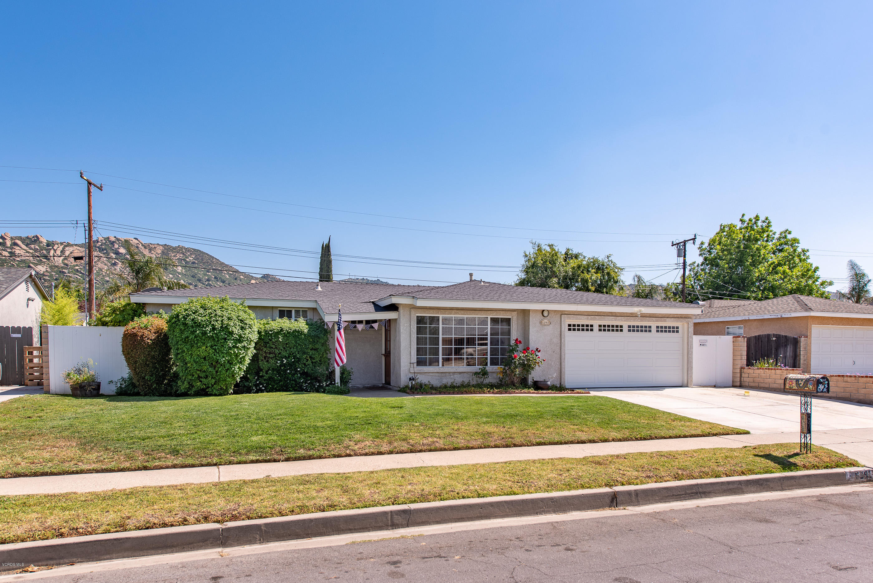 6292 Hope Street Simi Valley, CA 93063 - Photo 2 of 20 a view of a house with a big yard and large trees